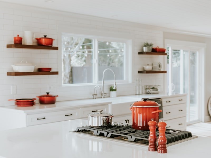 Modern remodeled kitchen with custom cabinetry, quartz countertops and a large island, completed by Oak & Stone Remodeling in Austin.